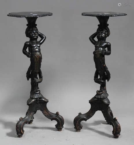 A pair of late 19th century Continental ebonized and carved softwood figural herm torchères,