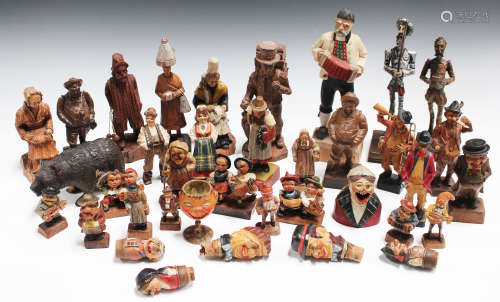 A collection of various Continental carved softwood figures, including a Black Forest standing