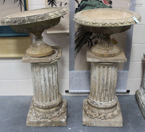 A pair of late 19th century moulded earthenware garden urns of shallow flower decorated form,