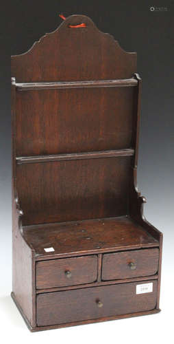 A mid-18th century provincial oak spoon rack/spice box, the two tiers of spoon holders above three