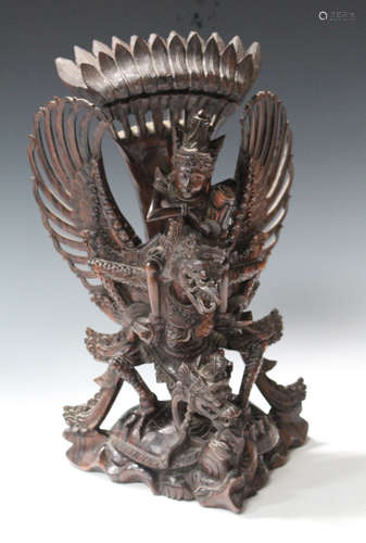 A 20th century Balinese carved hardwood figure group of Garuda and Vishnu, finely modelled with