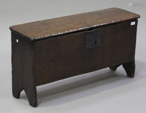 A 17th century oak six plank coffer, the interior fitted with a candle box, raised on shaped side