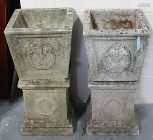 A pair of 20th century cast composition stone garden planters, the flared square bodies decorated