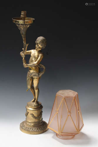 A 20th century gilt brass figural table lamp in the form of a standing putto, raised on a