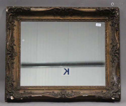 A 19th century gilt composition rectangular wall mirror, the frame decorated with leaf scrolls, 87cm