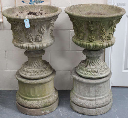 A pair of late 20th century cast composition garden urns, the flared trumpet bodies cast with