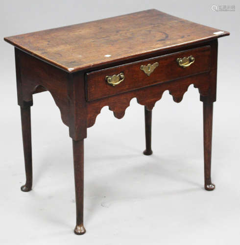 A mid-18th century provincial oak side table, fitted with a single drawer, on turned tapering legs