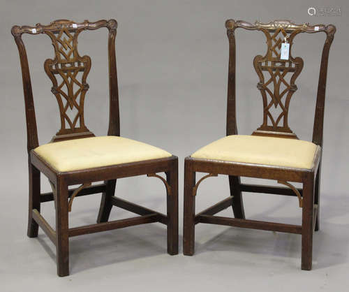 A pair of George III Chippendale period mahogany pierced splat back dining chairs with carved