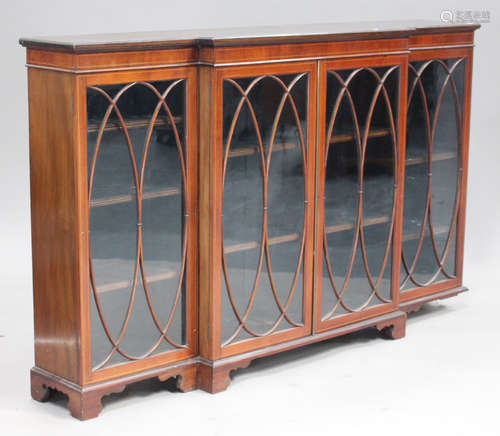 An Edwardian mahogany breakfront bookcase with line inlaid decoration, fitted with four astragal