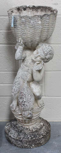 A late 20th century cast composition stone garden planter with a putto and dolphin support on a