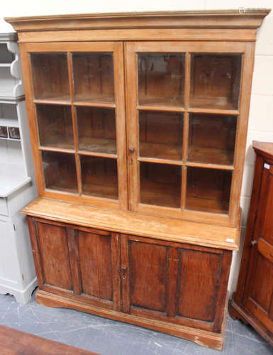 A mid-Victorian ash and pine kitchen cabinet, the moulded pediment above a pair of astragal glazed