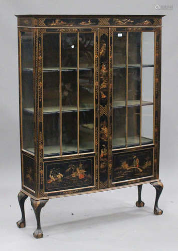 An early 20th century black chinoiserie display cabinet, decorated with figures, buildings and birds