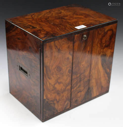 A late Victorian figured walnut table top cabinet, fitted with two doors and brass recessed handles,