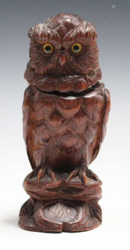 An early 20th century Swiss Black Forest carved softwood novelty inkwell in the form of an owl,
