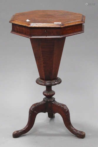 A Victorian walnut octagonal work table, raised on carved cabriole legs, height 73cm, width 43cm.