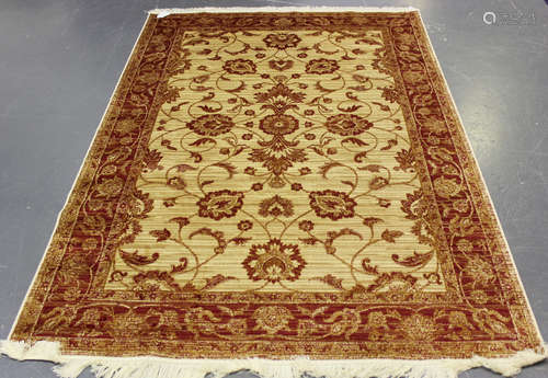 A modern machine made Ziegler style rug, the cream field with overall palmettes and curling