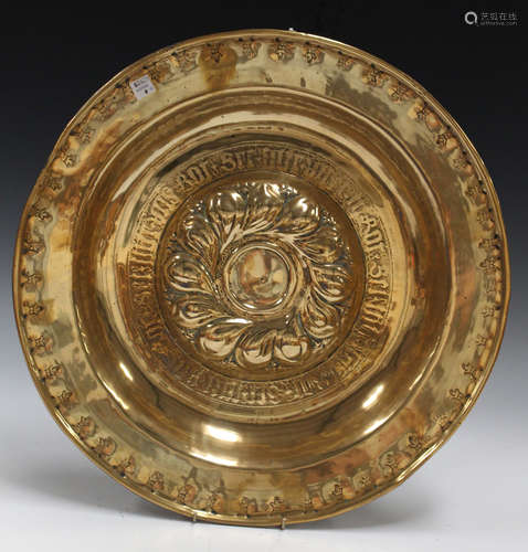 A 17th century Nuremberg brass alms dish, the central raised boss worked with a band of gadrooning