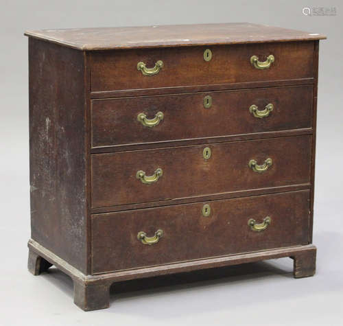 A George III provincial oak chest of four graduated long drawers, on bracket feet, height 100cm,