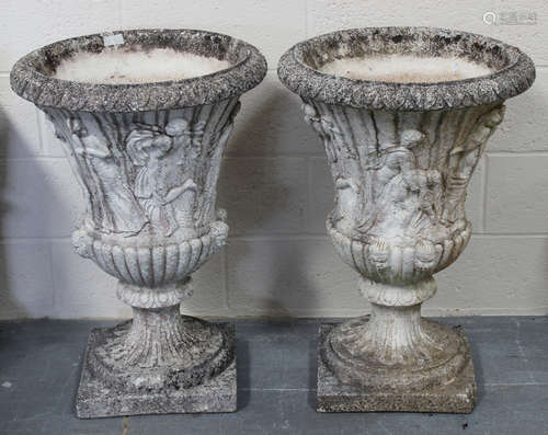 A large pair of 20th century cast composition garden urns, the flared bodies decorated in relief