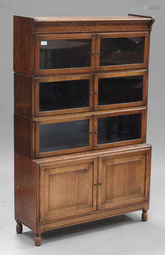 An early 20th century oak Globe Wernicke style glazed bookcase, on turned feet, height 141cm,