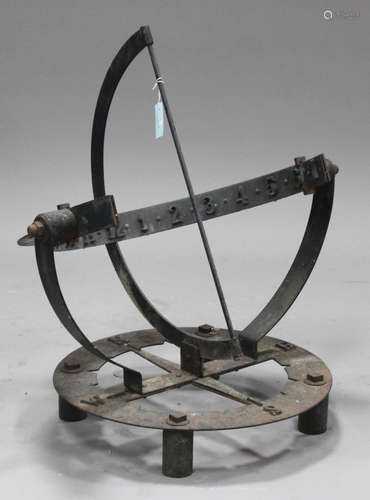 A 20th century wrought iron garden sundial, fitted with a curved band bearing Arabic numerals,