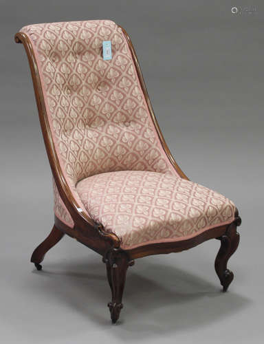 A mid-Victorian rosewood framed slipper chair with upholstered seat and back, on carved cabriole