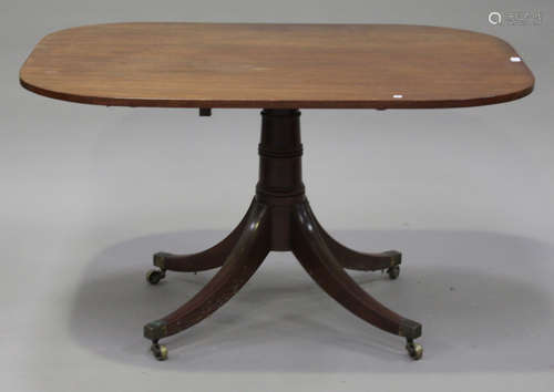 A George III mahogany tip-top breakfast table, the curved rectangular top on a turned column and