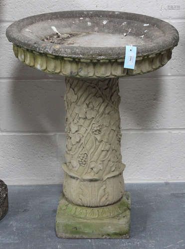 A late 20th century cast composition stone garden birdbath, the circular top raised on a