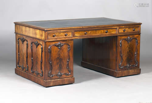 An early Victorian figured mahogany twin pedestal partners desk, the sides and doors with applied