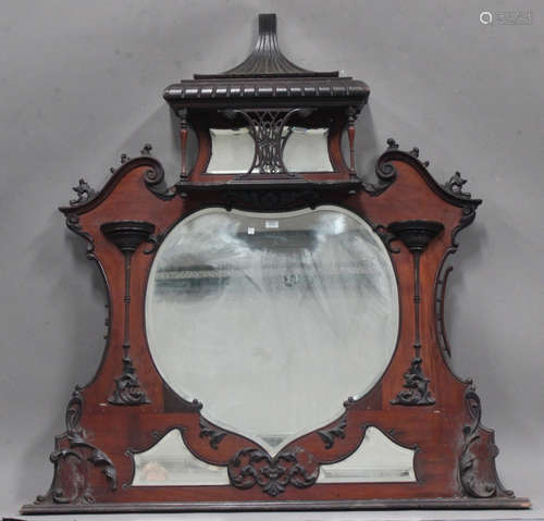 A Victorian mahogany overmantel mirror with applied moulded 'C' and leaf scroll decoration, fitted