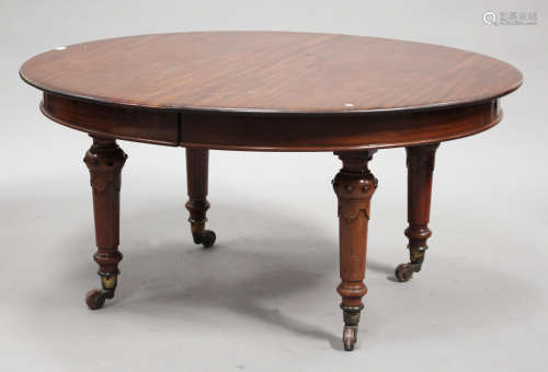 A mid-Victorian mahogany oval extending dining table, raised on beaded knop and turned tapering legs