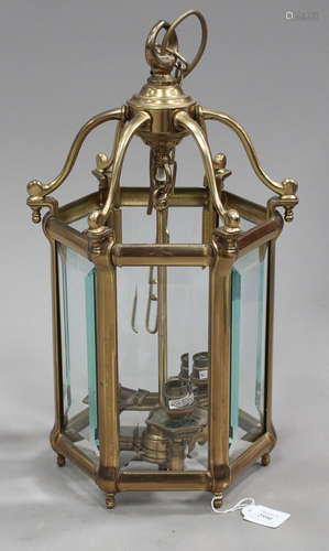 A late 20th century brass framed hexagonal hanging hall lantern, the sides inset with wide