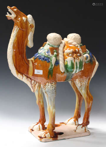 A Chinese Tang style glazed pottery model of a standing camel, height 67cm.Buyer’s Premium 29.4% (