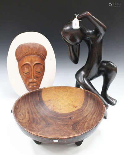 A mid-20th century African carved hardwood figure of stylized form, height 53cm, together with a