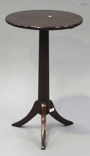 A 19th century and later mahogany circular wine table with a reeded stem and tripod legs, height