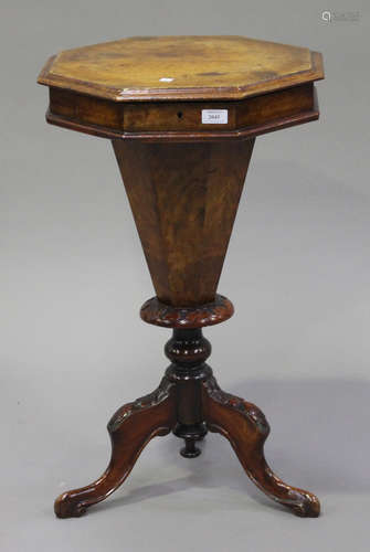 A late Victorian walnut octagonal work table, on a turned column and carved cabriole legs, height