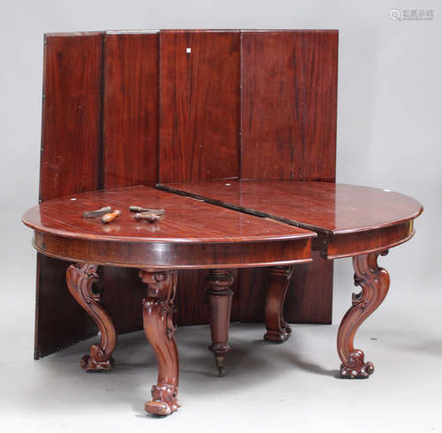 A large late Victorian mahogany extending dining table, the top with a double winding mechanism