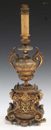 A late 19th century French Baroque Revival gilt bronze candlestick, the column of urn form applied