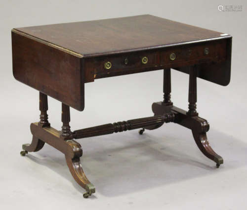 An early 19th century mahogany sofa table, crossbanded in rosewood, fitted with two frieze drawers