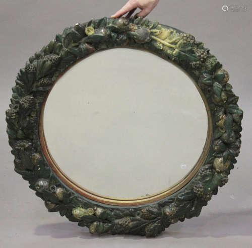 A 19th century Continental moulded composition circular wall mirror, modelled with a wide band of