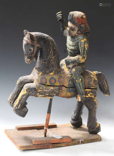 A 20th century Indian painted and carved wooden equestrian figure group of a warrior on horseback,