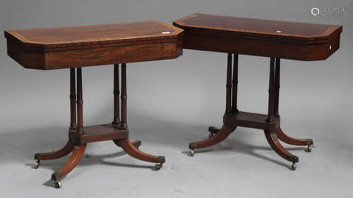 A pair of George IV mahogany fold-over card tables, each canted top with a satinwood and line inlaid