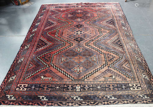 A Shiraz carpet, South-west Persia, mid/late 20th century, the red field with three linked