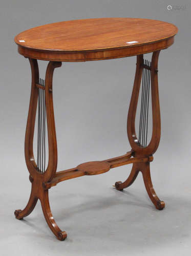 An Edwardian satinwood oval occasional table, raised on twin lyre supports and scroll feet, height