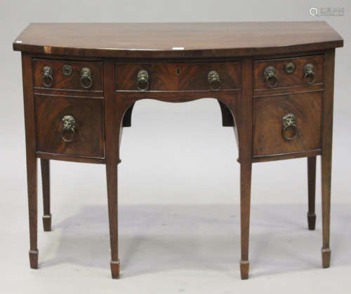 A George III mahogany kneehole bowfront sideboard, fitted with a single frieze drawer and two