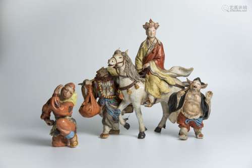 A Group of Porcelain Figures depicting Monk and Disciples on Journey to the West