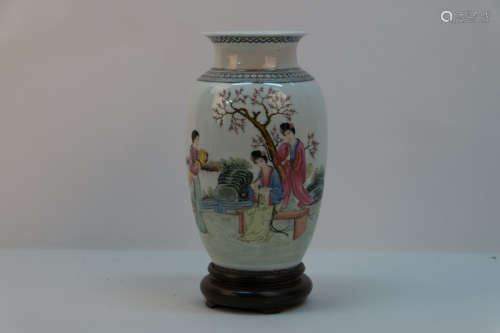 A chinese porcelain bottle with wood base