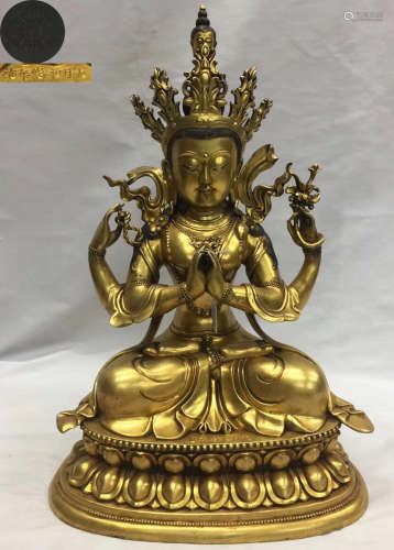 A GILT BRONZE MOLDED FOUR-ARM GUANYIN STATUE