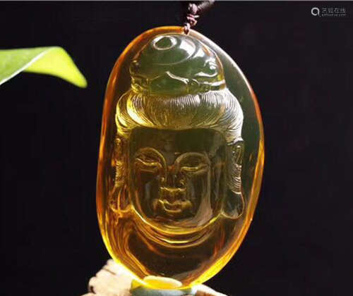 A MYANMAR AMBER GUANYIN SHAPED PENDANT