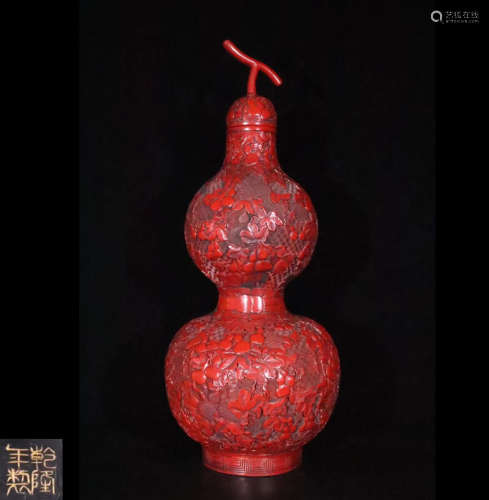 A RED LACQUER GOURD SHAPED VASE